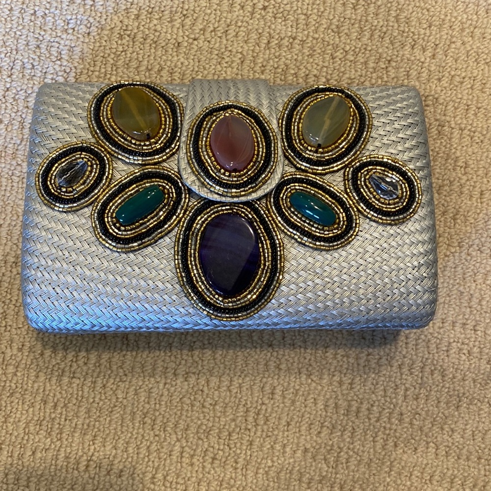 Silver woven clutch with jeweled detail. Silver chain. Excellent condition